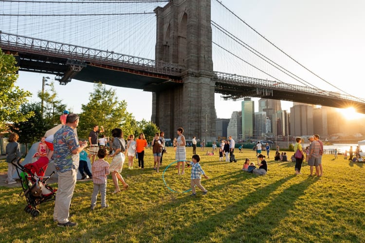 Different groups of people having fun at Brooklyn Bridge Park