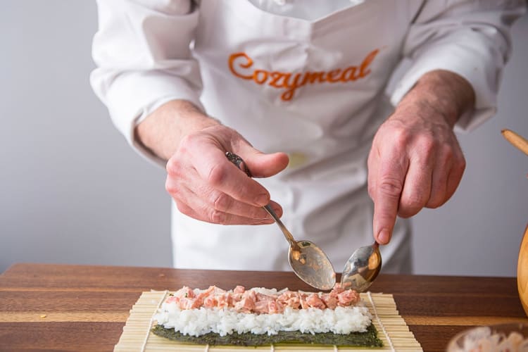 Close-up of a chef's hands making sushi