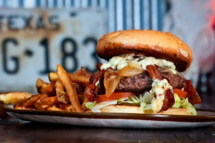 Eye-level view of a burger and fries, from Fred's Texas Café, a diner in Fort Worth