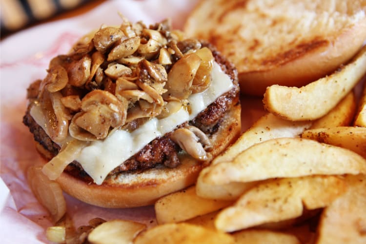 Mushroom and Swiss burger served with fries