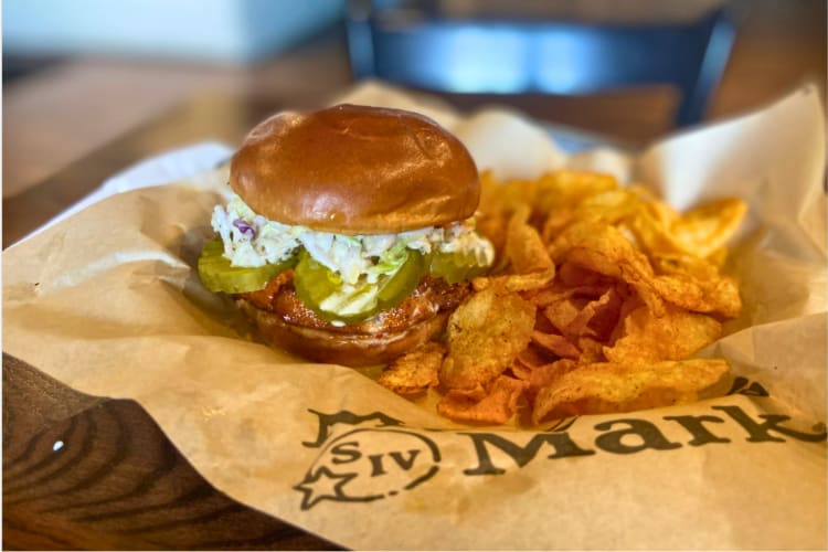 Spicy chicken sandwich served with chips