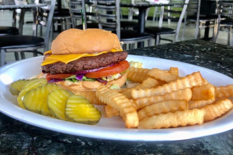 Classic cheeseburger with fries and pickles