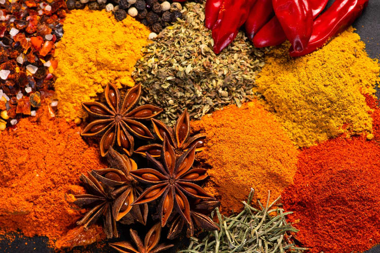 Assorted variety of natural spices on a dark background