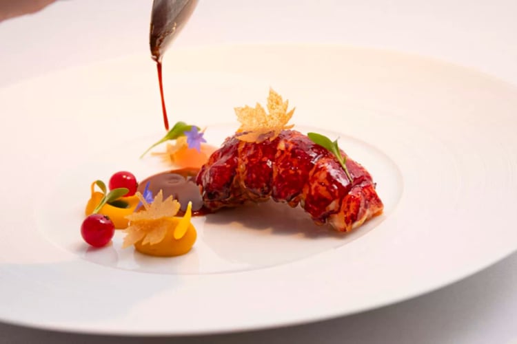 Barbecue lobster with edible flowers and purees