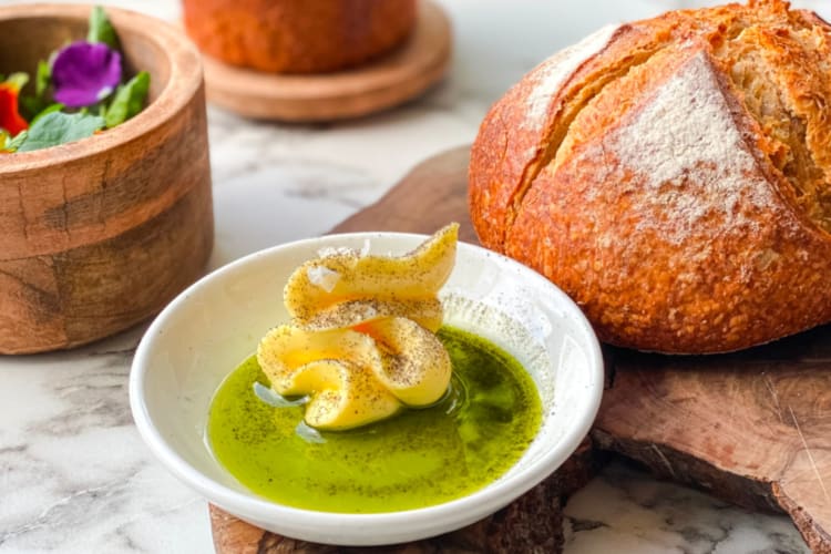 Homemade bread next to butter and oil