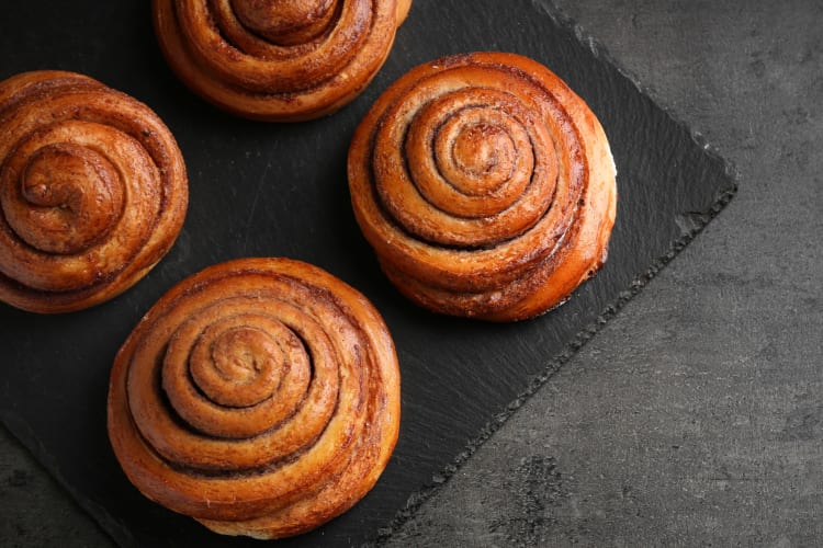 Glazed coffee roll served on an iron board