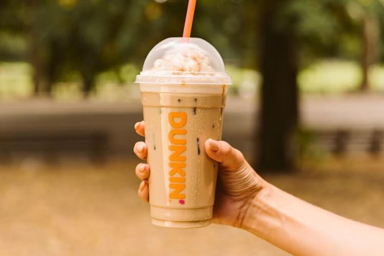 A hand holding a Dunkin' Donuts iced coffee
