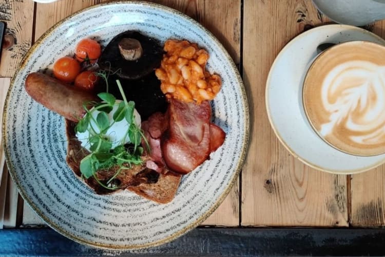 A cooked Edinburgh breakfast with a coffee