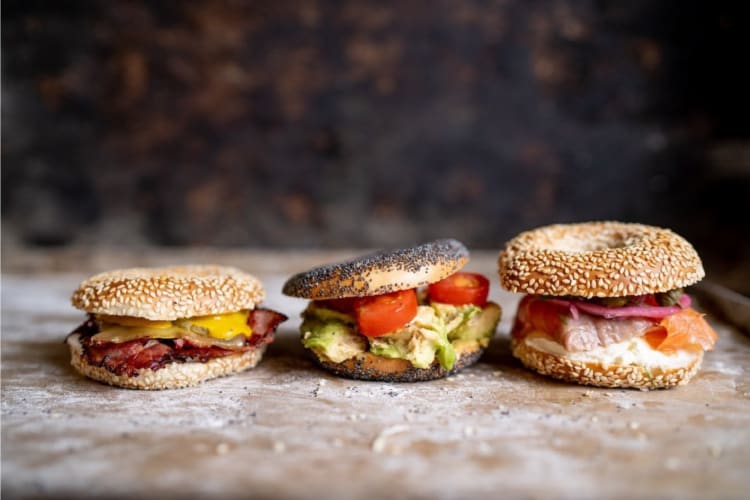 three bagel sandwiches lined up in a row