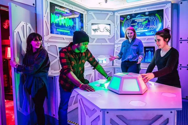 Four people working together in an escape room