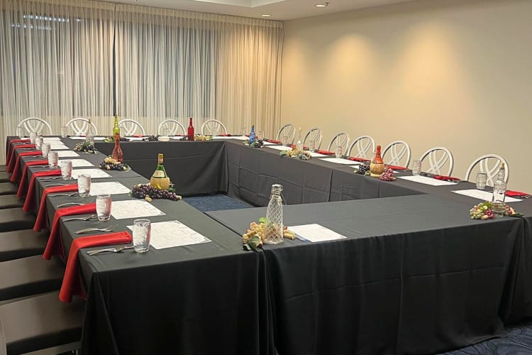 A boardroom at the Ravinia Green Country Club set up with long tables and chairs
