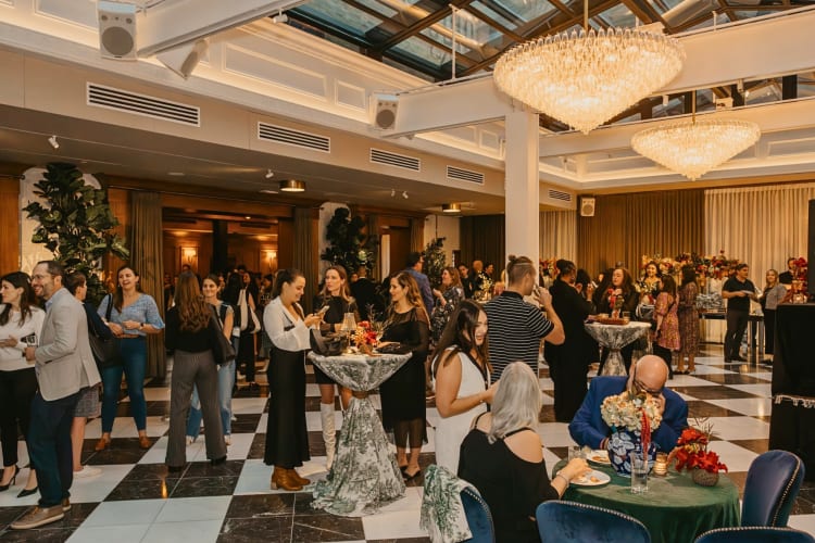 A room filled with mingling people at Salon 61, a lovely event space in Chicago