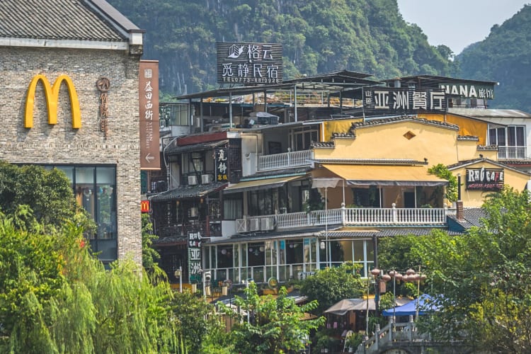 The facade of the McDonald's in Yangshuo, China, next to another restaurant