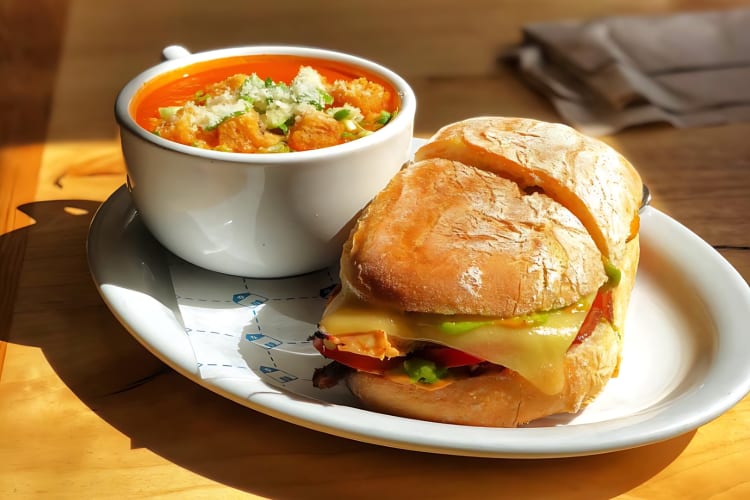 Tomato basil soup served with a sandwich