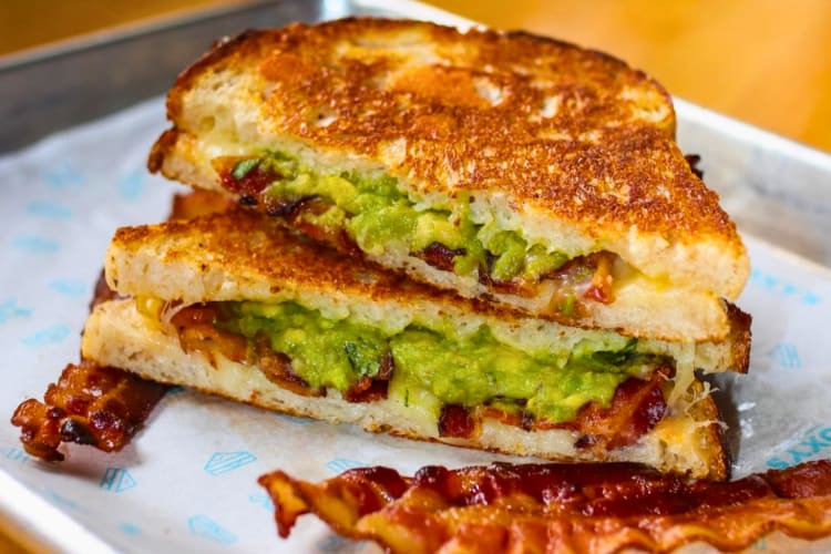 Grilled cheese served with bacon and housemade guacamole