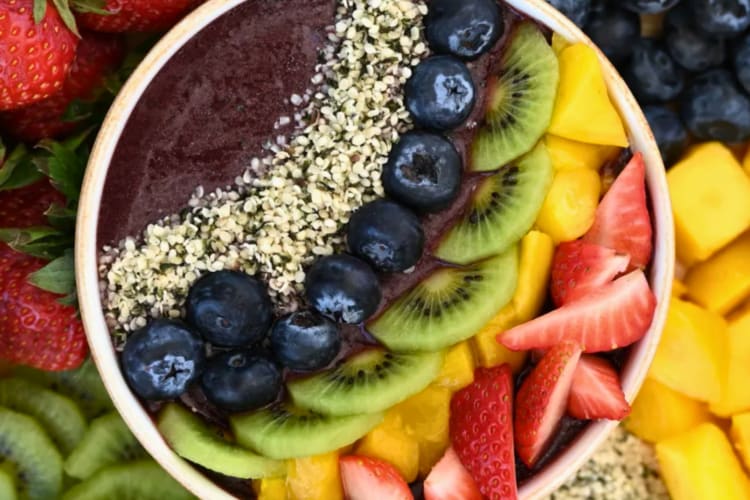 Rainbow açaí bowl served with assorted fruits