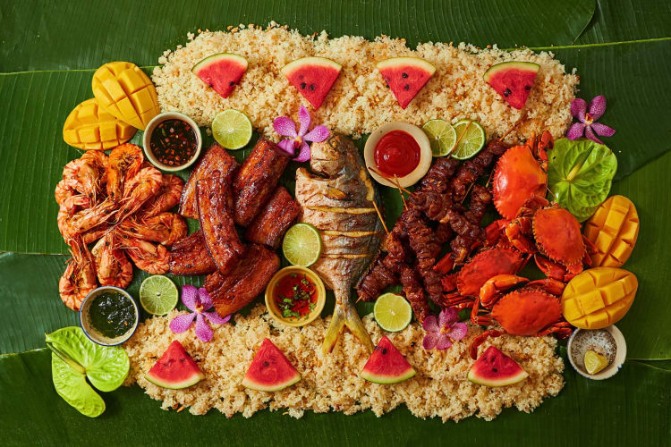 A variety of Filipino foods served on large leaves