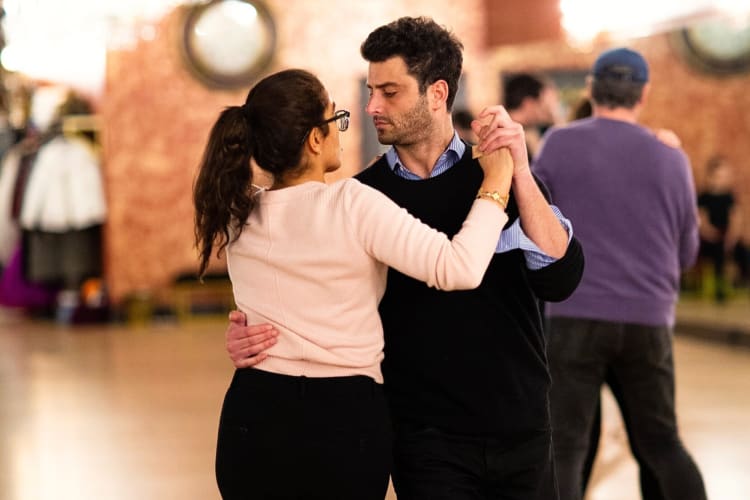 A man and woman dancing together during a dance lesson