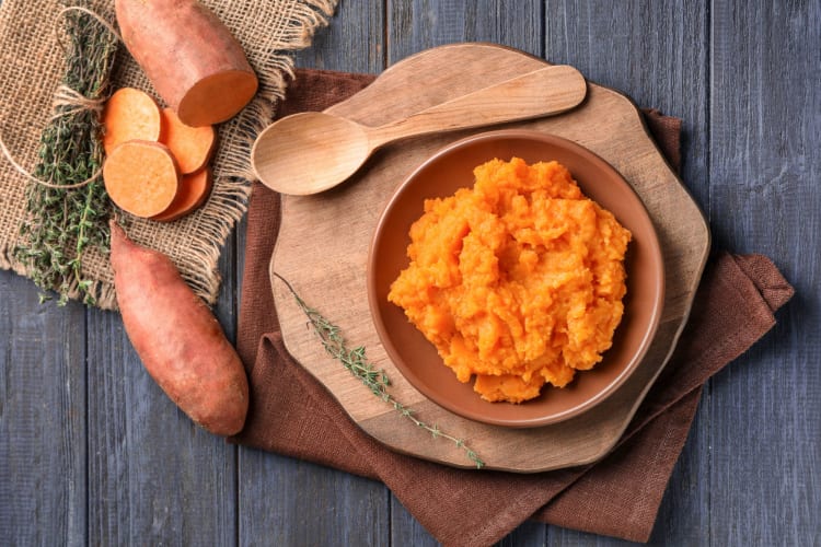 A bowl of mashed sweet potato.