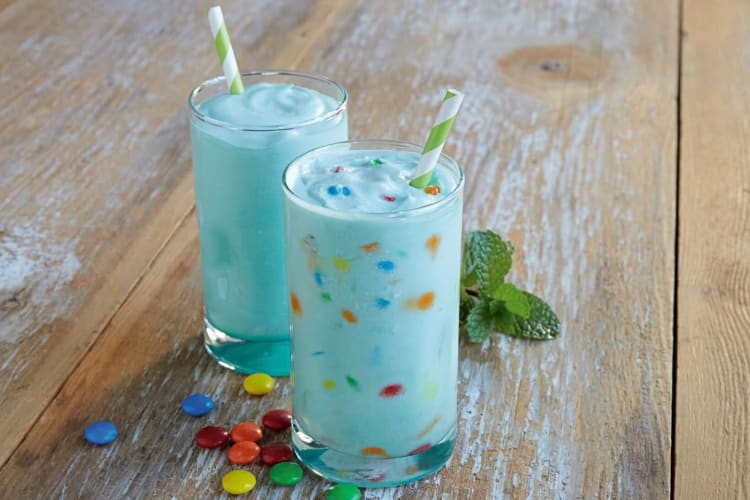 Two shakes next to loose smarties from Del Taco