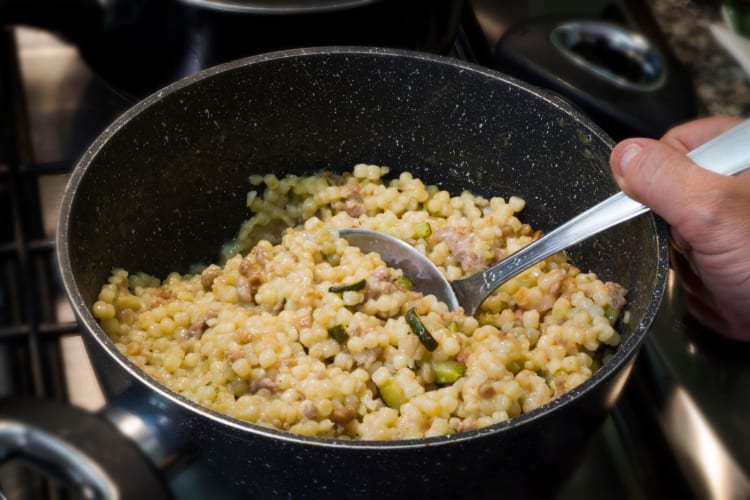 Cooking fregola on a pan