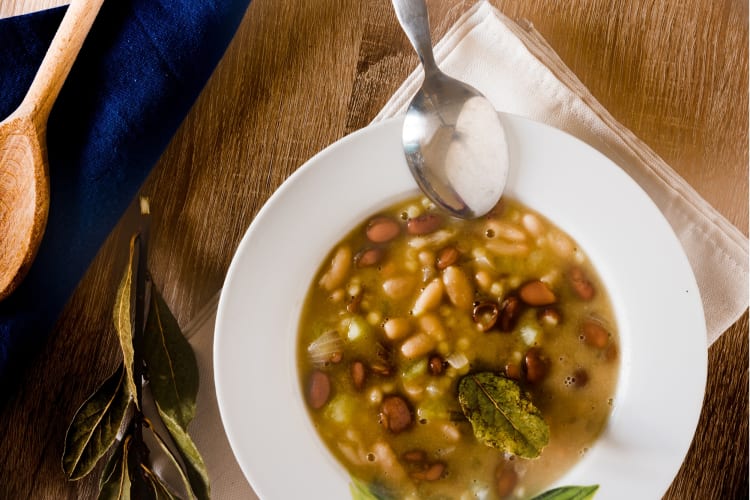 Fregola and beans soup served on a plate