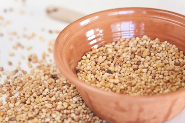 Fregola on a ceramic bowl and overflowing