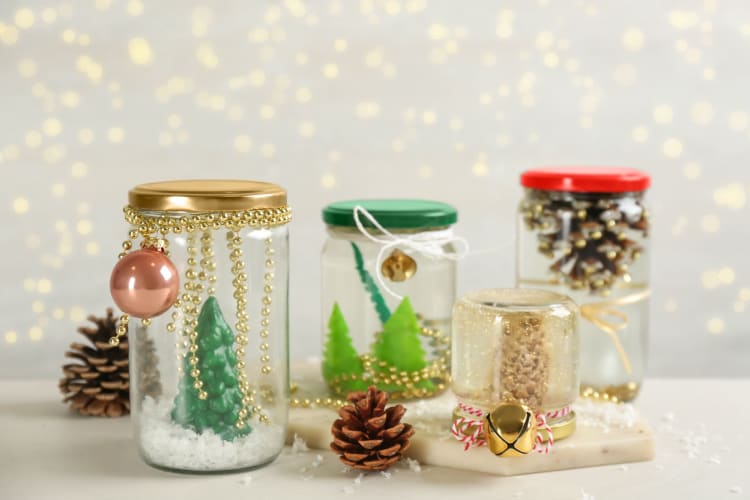 Handmade Snow Globes and Fir Cones on Light Table.