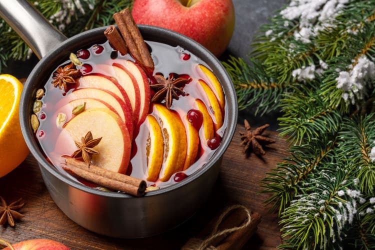A saucepan of mulled wine with fruits and spices is a fun christmas activity.