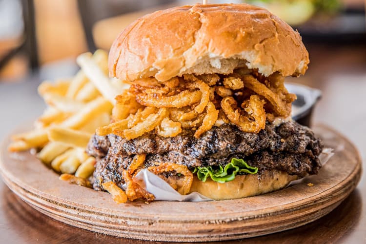  A5 Hyogo wagyu burger topped with fringlings served with fries
