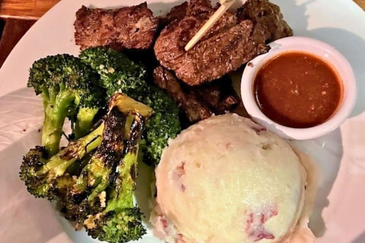 Garlicky sirloin strips, mashed potato and greens.