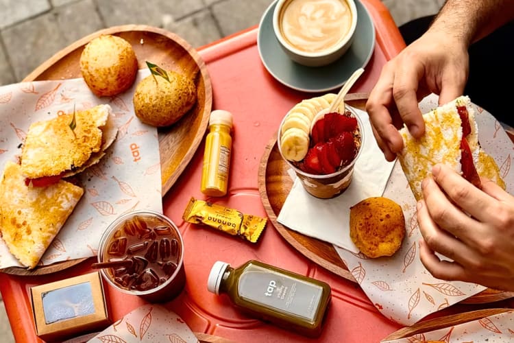 Hands holding a crêpe from TAP, a gluten-free restaurant in NYC
