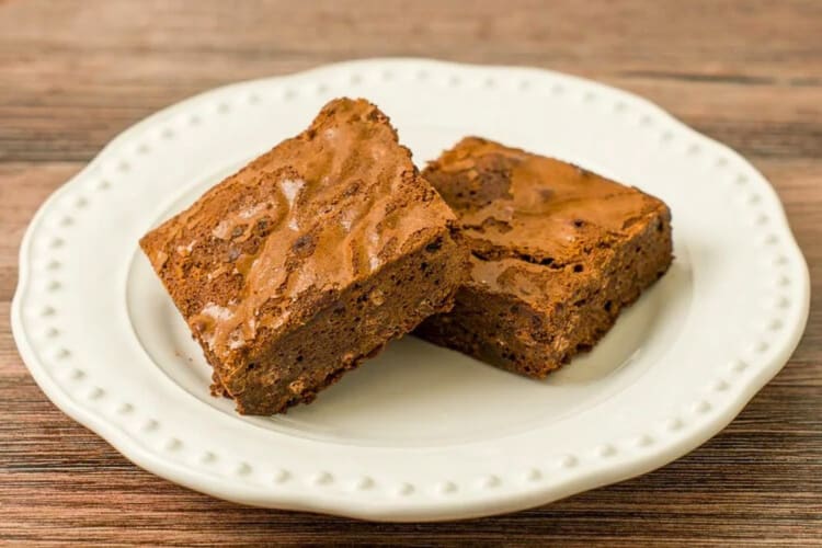 Two brownies on a white plate from By the Way Bakery in NYC