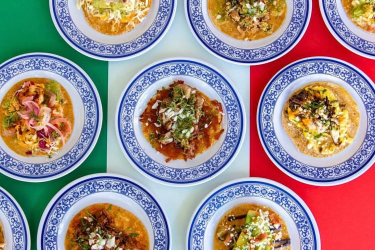 Different tacos on plates from La Esquina in NYC