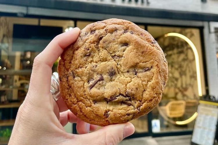 A hand holding a cookie from Modern Bread and Bagel in NYC