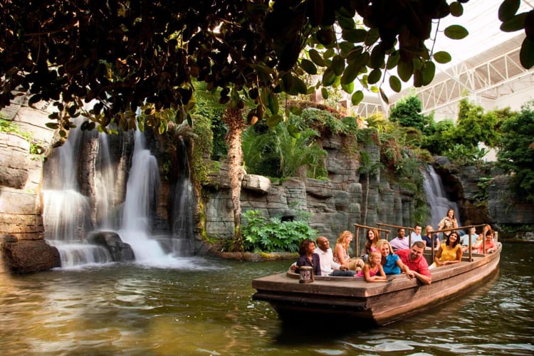 People on a boat cruise on the lazy river at Gaylord Opryland Resort