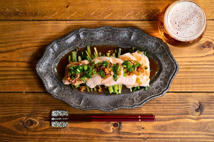 A plate of steamed fish with ginger and scallions.