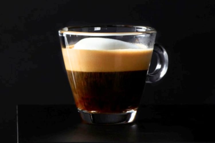 a rich espresso marked with dollop of steamed milk and foam.