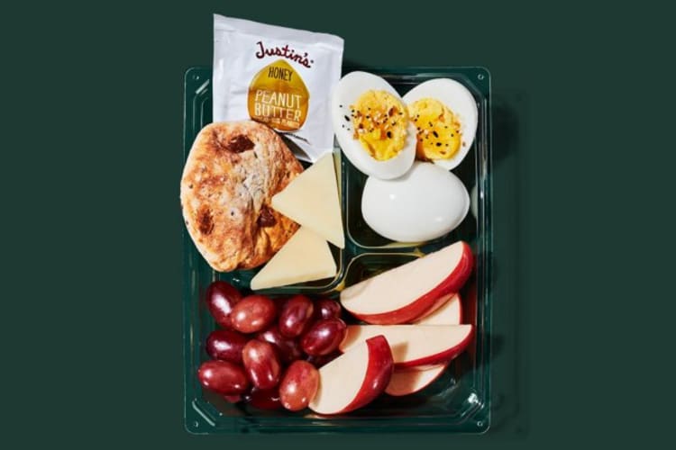 A snack box with salami, cheese, crackers and trail mix