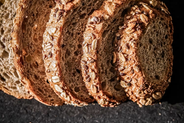 A loaf of sliced seeded bread.