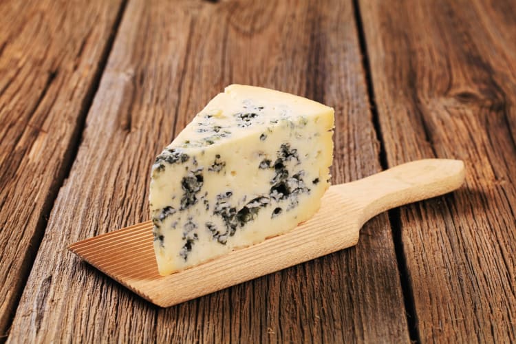 A block of blue cheese, which is one of the healthiest cheeses