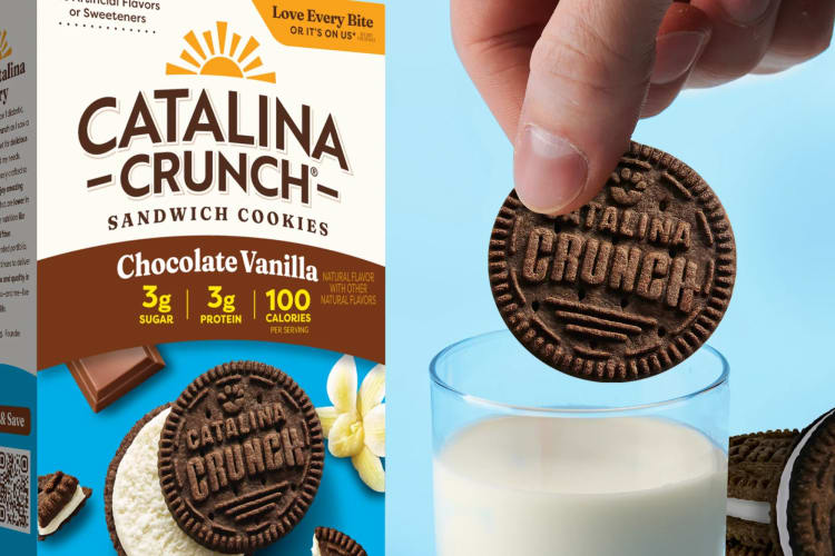 A box of cookies and a cookie being dunked in a glass of milk.