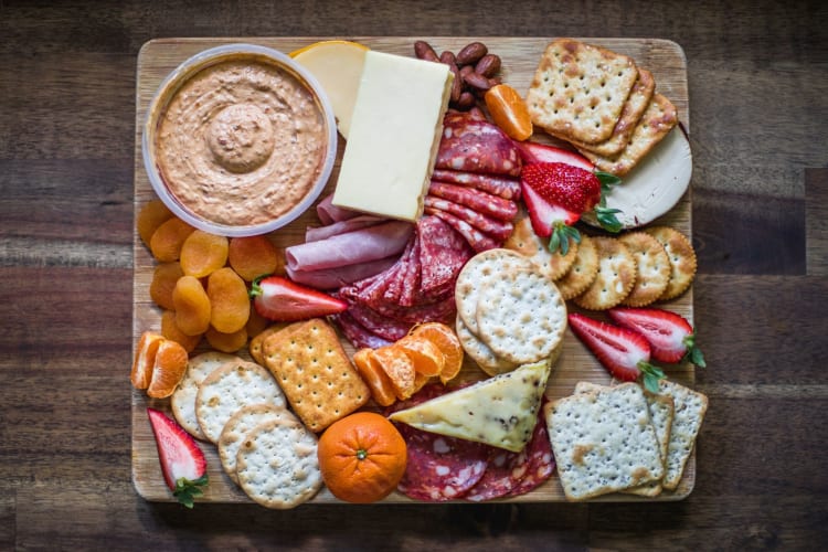 A charcuterie board featuring low-calorie crackers.