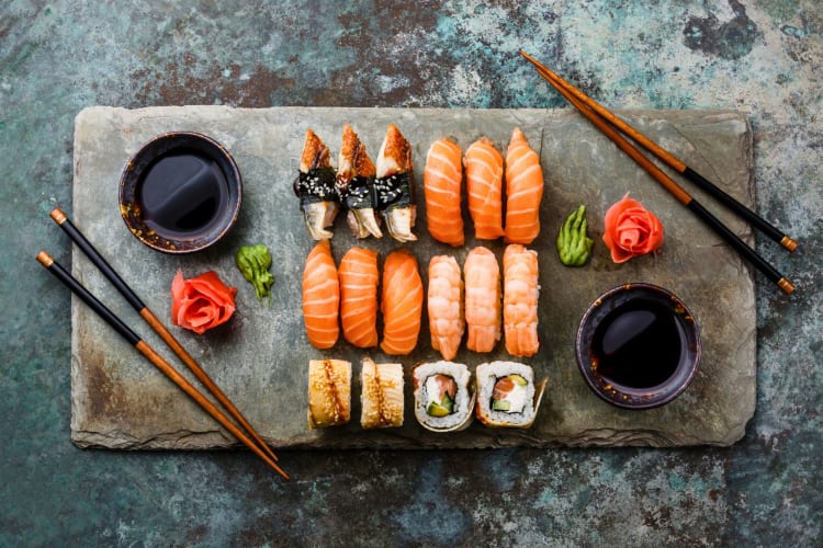 Sushi set containing sashimi and sushi rolls.