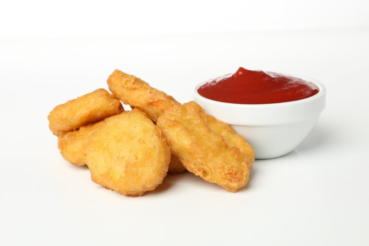 Four piece chicken nuggets served with ketchup