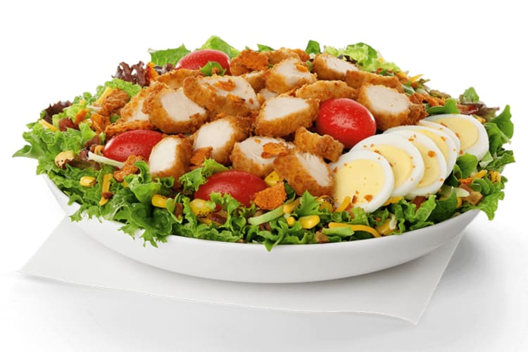 Chicken on a fresh bed of mixed greens with roasted corn, cheese, bacon, sliced hard-boiled egg and grape tomatoes. 