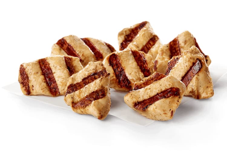 Bite-sized pieces of freshly marinated boneless breast of grilled chicken.