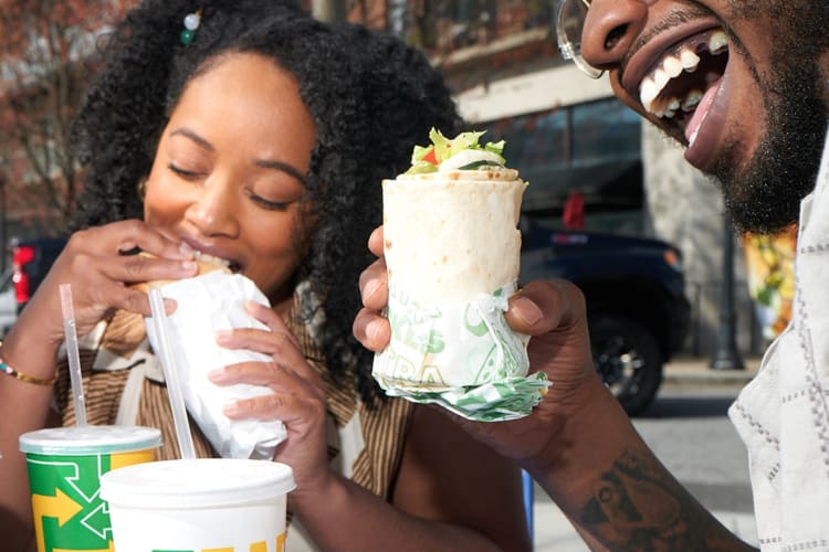 Two people eating the healthiest items at subway.