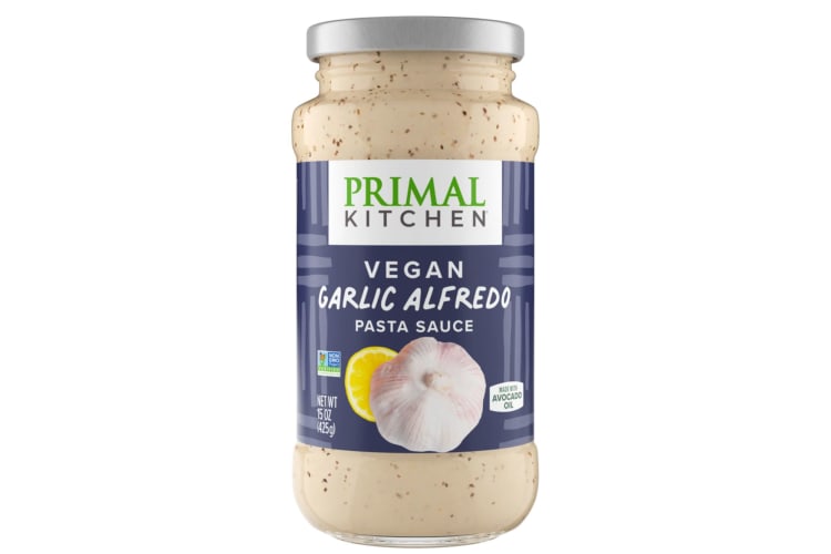 A jar of Primal Kitchen Vegan Garlic Alfredo Sauce.