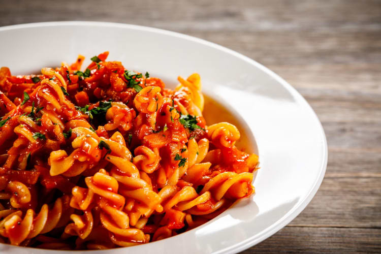 A bowl full of tomato pasta.